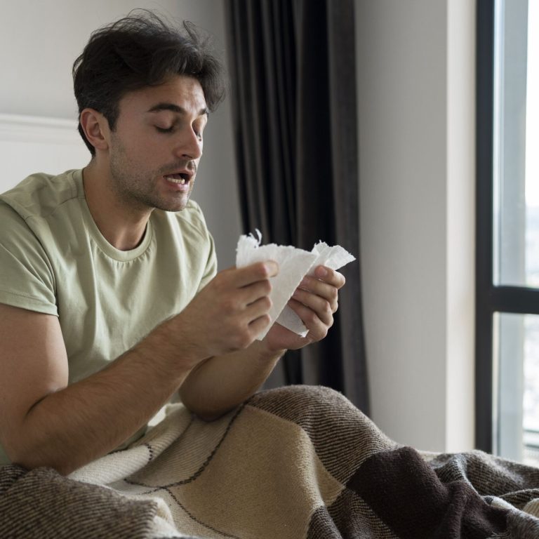 medium-shot-man-holding-tissues (1)
